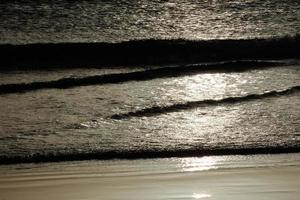 lonely, uncrowded beach with calm sea and small waves photo