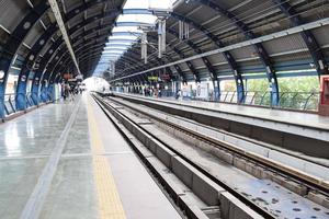 New Delhi India - June 21 2022 - Delhi Metro train arriving at Jhandewalan metro station in New Delhi, India, Asia, Public Metro departing from Jhandewalan station photo