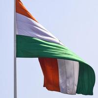 India flag flying high at Connaught Place with pride in blue sky, India flag fluttering, Indian Flag on Independence Day and Republic Day of India, tilt up shot, Waving Indian flag, Har Ghar Tiranga photo