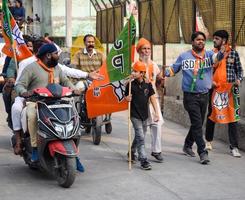 Delhi, India, December 02 2022 - Bharatiya Janata Party BJP supporter during mega road show in support of BJP candidate Pankaj Luthara to file nomination papers ahead of MCD local body Elections 2022 photo