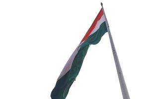 India flag flying high at Connaught Place with pride with plain white background, India flag fluttering, Indian Flag on Independence Day and Republic Day of India, tilt up shot, Har Ghar Tiranga photo