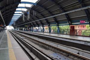 New Delhi India - June 21 2022 - Delhi Metro train arriving at Jhandewalan metro station in New Delhi, India, Asia, Public Metro departing from Jhandewalan station photo