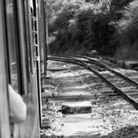 Shimla, Himachal Pradesh, India - May 14, 2022 - Toy train Kalka-Shimla route, moving on railway to the hill, Toy train from Kalka to Shimla in India among green natural forest photo