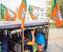 Delhi, India, December 02 2022 - Bharatiya Janata Party BJP supporter during mega road show in support of BJP candidate Pankaj Luthara to file nomination papers ahead of MCD local body Elections 2022 photo