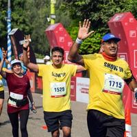 New Delhi, India - October 16 2022 - Vedanta Delhi Half Marathon race after covid in which marathon participants about to cross the finish line, Delhi Half Marathon 2022 photo