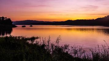 landscape sunset with Reservoir and raft house Thailand photo