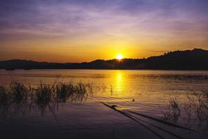 landscape sunset with Reservoir and raft house Thailand photo