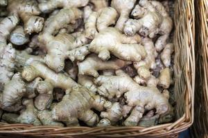 Ginger in a basket on the supermarket counter, sell ginger roots in a vegetable store photo