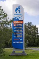 Sosnovy Bor, RUSSIA-SEPTEMBER 03.2021 Gazpromneft gas station stand with prices, street gas station with fuel prices photo