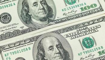 Lot of one hundred dollar bills close up background photo