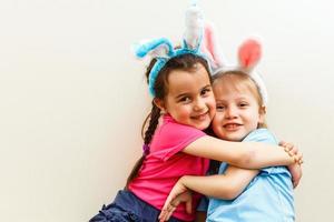 Two little girls secrets isolated on white background photo