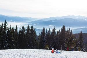 Portrait of smiling couple on skis in the mountains photo