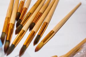 Set of brushes for painting pencils spatula in the bank against the backdrop photo