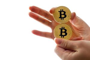 Two golden bitcoin in  hand digitall symbol of a new virtual currency isolated on white photo