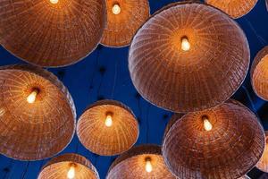 lamps in straw shades on the ceiling for decoration photo