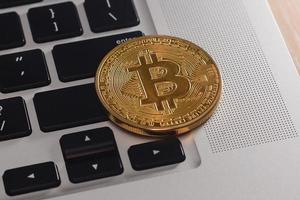 Golden bitcoin on keyboard photo