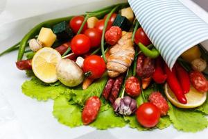 A set of vegetables, sausages and cheese. The original bouquet. photo