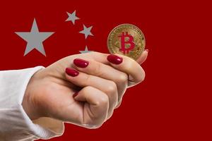 Bitcoin close up on keyboard background the flag of china is shown on bitcoin photo
