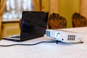 Laptop on table and speaking man at business meeting photo