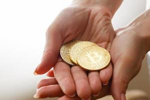 Two golden bitcoin in  hand digitall symbol of a new virtual currency isolated on white photo