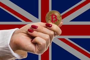 Physical version of bitcoin new virtual money and uk flag conceptual image for investors in photo