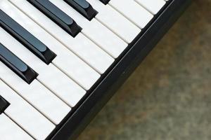 Black and white piano keys with written notes top view the concept of music photo