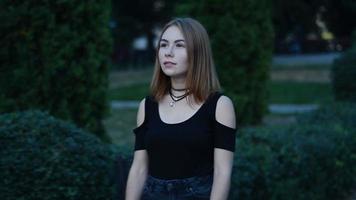 young charming girl walking alone through the city late in the evening, close up video