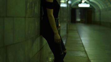 pin up girl with short hair and glasses posing in the evening near a stone wall video