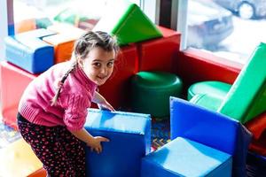 Cute girl playing with soft cubes photo