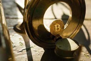 Metal gears wheels with bitcoin on a copper background photo