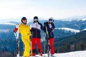 Portrait of smiling skiers in the mountains photo