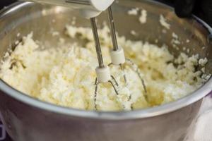 the mixer stirs the cottage cheese photo