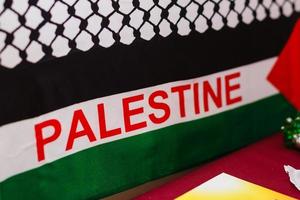 Realistic flag of palestine on the wavy surface of fabric this flag can be used in design photo