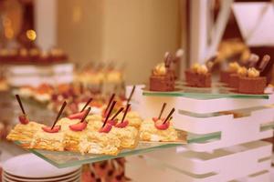 Light dessert a classic napoleon or millefeuille cake decorated with mint and strawberries on photo