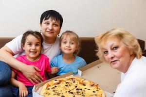 Family Eating Pizza Together at home photo