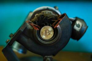 Metal gears wheels with bitcoin on a copper background photo