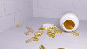 Falling medicine in capsules on a light background