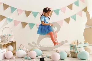 Cute little girl with bunny ears and basket of Easter eggs photo