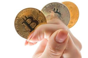 hand holds three coins of digital currency bitcoin photo