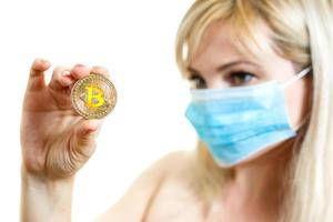 Closeup portrait of a young doctor wearing a mask isolated on white background bitcoin photo