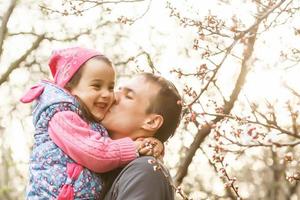 Father's day. Dad kissing his daughter.Happy smiling child with parent. Family portrait. photo