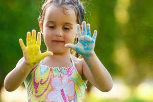 Little girl show painter hand walking in the park photo