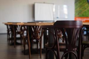 Inside the old classroom with blackboard, desks and chairs. photo