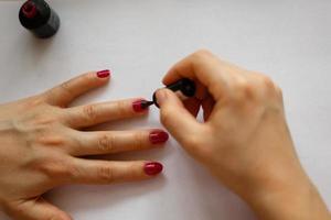 A woman doing manicure focus on her hands photo