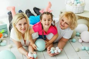 happy family with easter eggs. Happy llittle girl and grandmother with Easter eggs photo