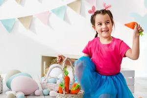 Cute little girl with bunny ears and basket of Easter eggs photo