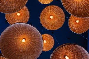 lamps in straw shades on the ceiling for decoration photo