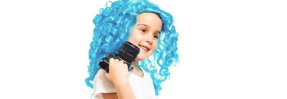 Funky style beauty. Cute baby with long blue hair. Small child wear blue wig hair. Small kid in fancy wig hairstyle. Adorable little child in fashion wig. Beauty look hairstyle for cosplay party. photo