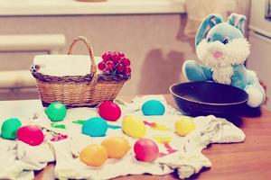 painting Easter eggs on table photo