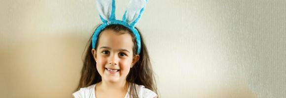 Happy lost tooth little girl wearing funny bunny ears photo